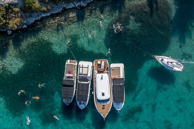 Split/Trogir: Blue Cave, Vis, and Hvar Speedboat Day Tour - Budikovac Blue Lagoon: snorkeling gear, clear water, and a simple bar stop